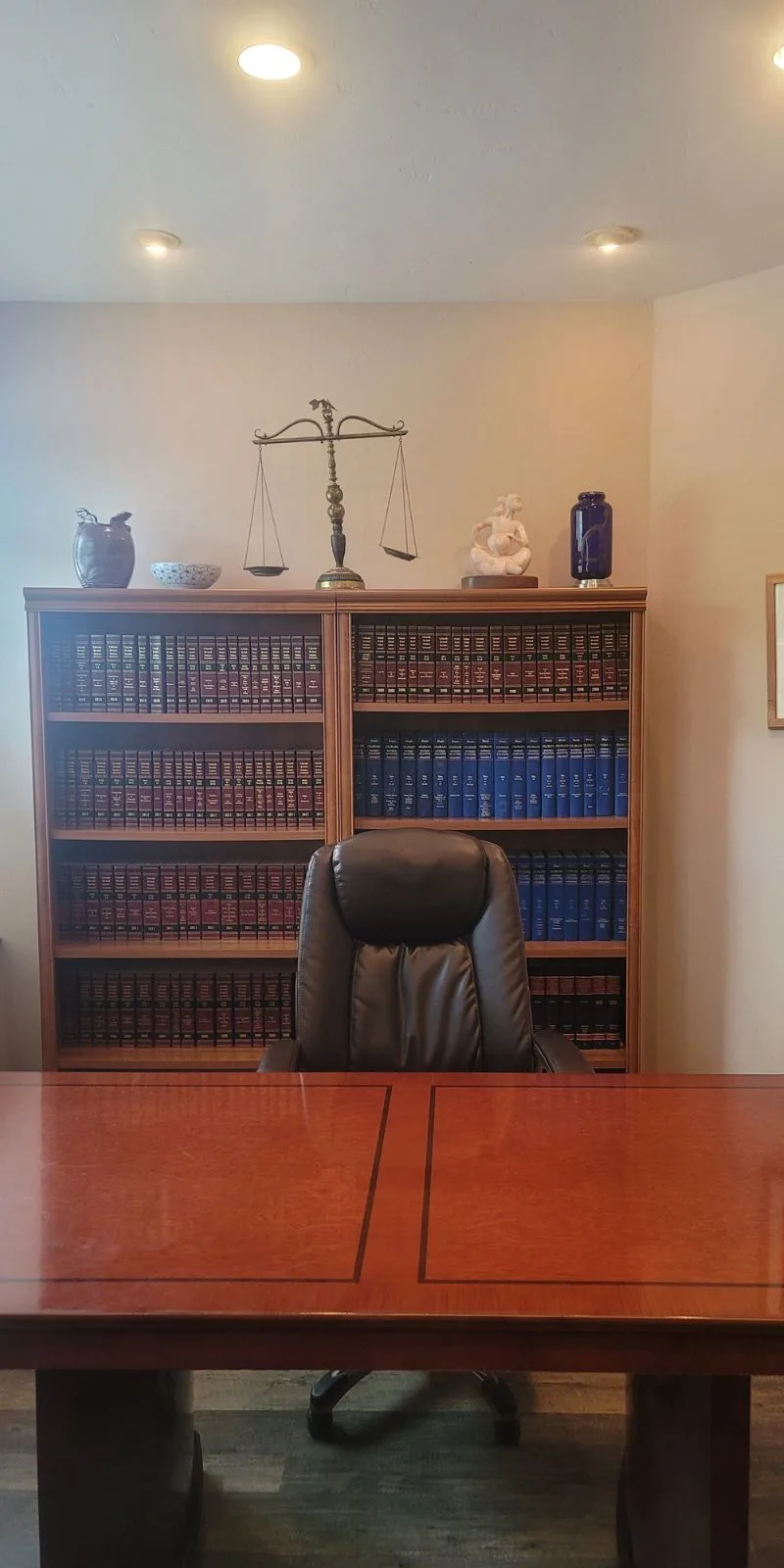 Law office with scales of justice and legal reference library